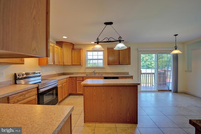 170 Otter Way, Frederica, DE 19946 - kitchen featuring stainless steel electric range oven, a center island, light countertops, light tile patterned flooring, and hanging light fixtures