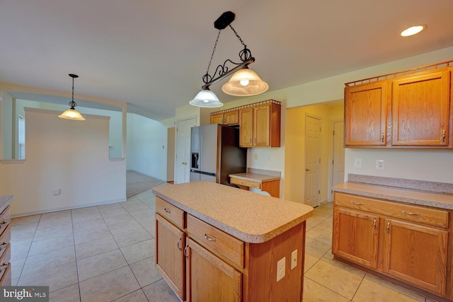 170 Otter Way, Frederica, DE 19946 - kitchen with refrigerator with ice dispenser, light countertops, a kitchen island, light tile patterned flooring, and recessed lighting