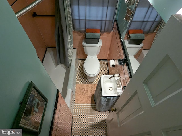 bathroom featuring shower / tub combo, toilet, and tile patterned floors