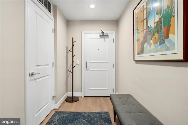 doorway to outside with visible vents, baseboards, wood finished floors, and recessed lighting