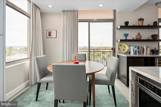 dining space with recessed lighting and baseboards
