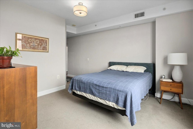 bedroom featuring baseboards, visible vents, and carpet