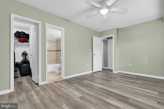 3906 Bel Pre Rd Unit 3906-1, Silver Spring, MD 20906 - unfurnished bedroom with ensuite bathroom, a closet, wood finished floors, a walk in closet, and baseboards