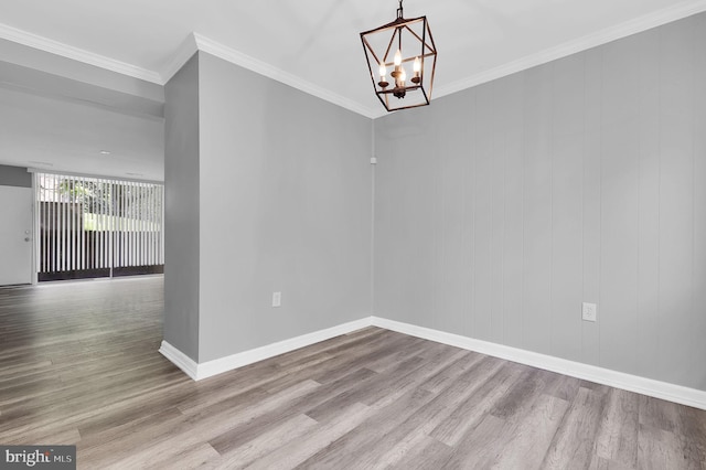 3906 Bel Pre Rd Unit 3906-1, Silver Spring, MD 20906 - spare room featuring baseboards, ornamental molding, an inviting chandelier, and wood finished floors