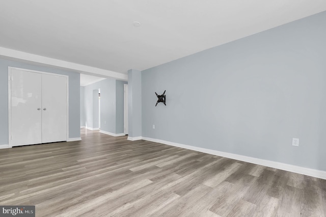 3906 Bel Pre Rd Unit 3906-1, Silver Spring, MD 20906 - unfurnished living room with baseboards and wood finished floors