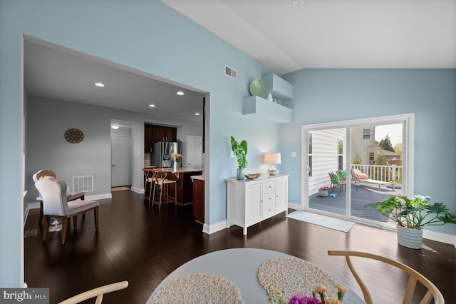 living area with baseboards, visible vents, dark wood finished floors, and lofted ceiling