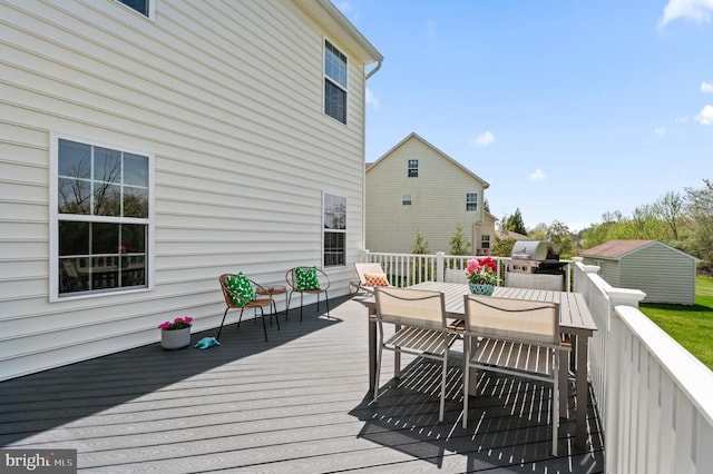 wooden deck with grilling area and outdoor dining space