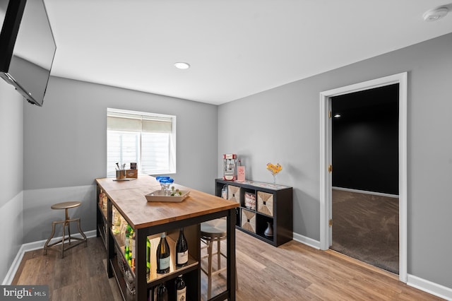 dining room with baseboards, recessed lighting, and wood finished floors