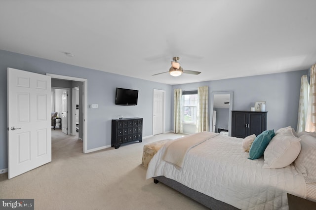 bedroom with carpet floors, a ceiling fan, baseboards, and a closet