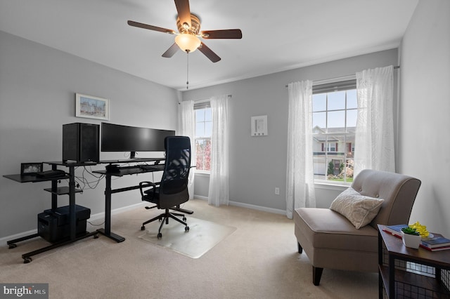 carpeted office with baseboards and ceiling fan