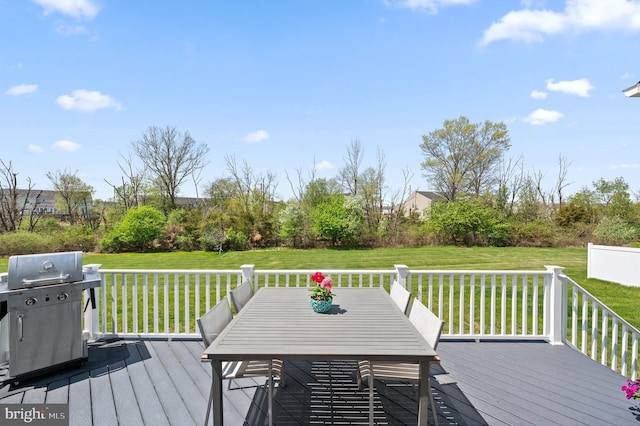 deck featuring a yard, outdoor dining area, and a grill