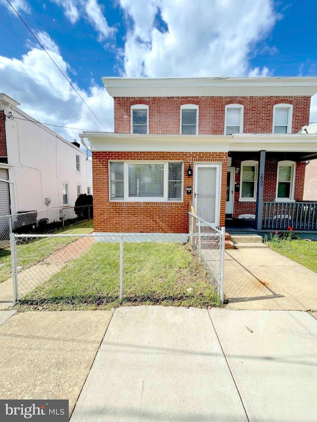 2905 N Madison St, Wilmington, DE 19802 - townhome / multi-family property with fence, a front lawn, a porch, and brick siding