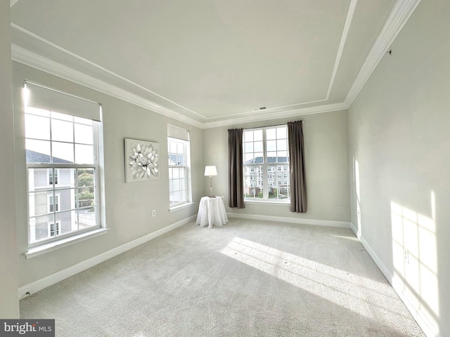 carpeted spare room with visible vents, baseboards, and ornamental molding
