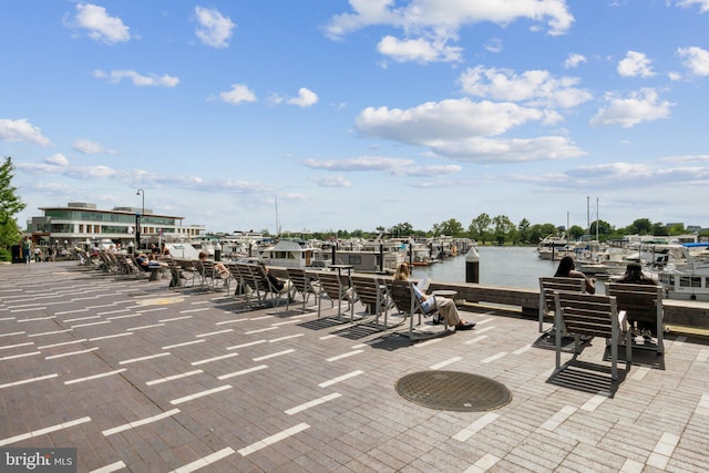 view of patio featuring a water view and a boat dock