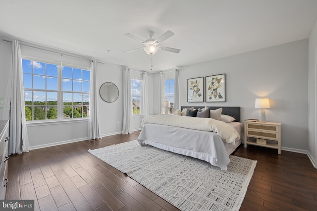 bedroom featuring baseboards, dark wood-style flooring, and ceiling fan