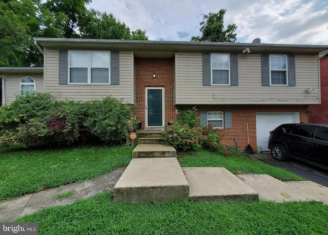 5909 K St, Fairmount Heights, MD 20743 - split foyer home featuring a front lawn, brick siding, aphalt driveway, and a garage