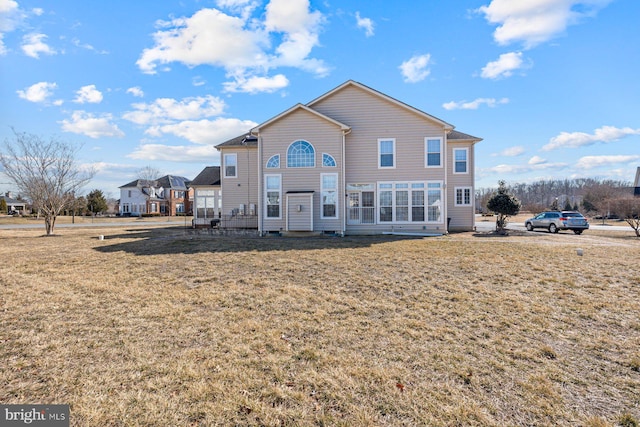 back of property with a lawn