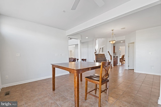 dining space featuring stairway, visible vents, a ceiling fan, light tile patterned floors, and baseboards