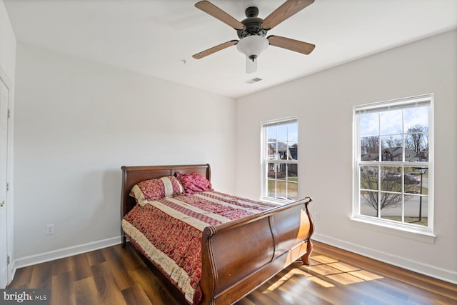 bedroom featuring ceiling fan, baseboards, and wood finished floors