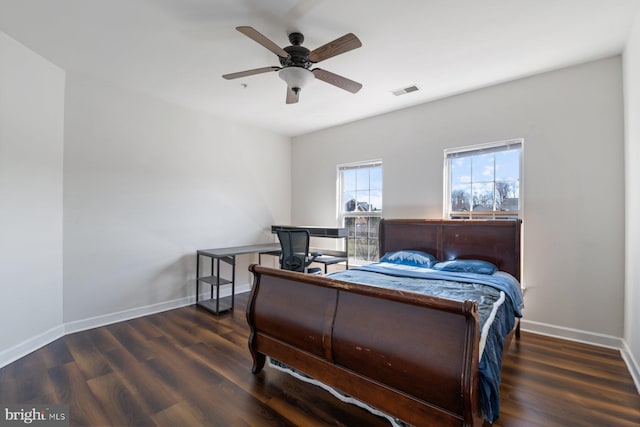 bedroom with wood finished floors, visible vents, and baseboards