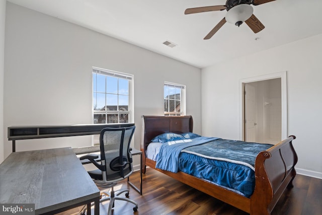 bedroom with visible vents, baseboards, wood finished floors, and ceiling fan
