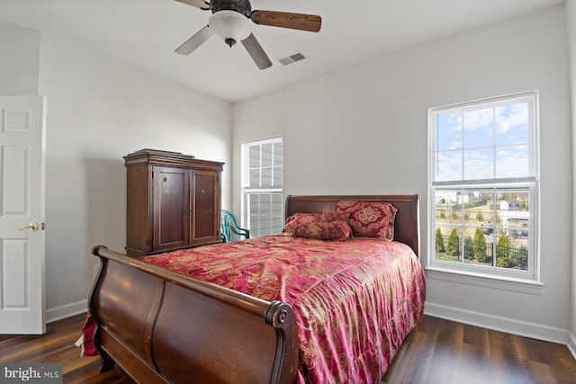 bedroom with ceiling fan, baseboards, dark wood-style flooring, and visible vents