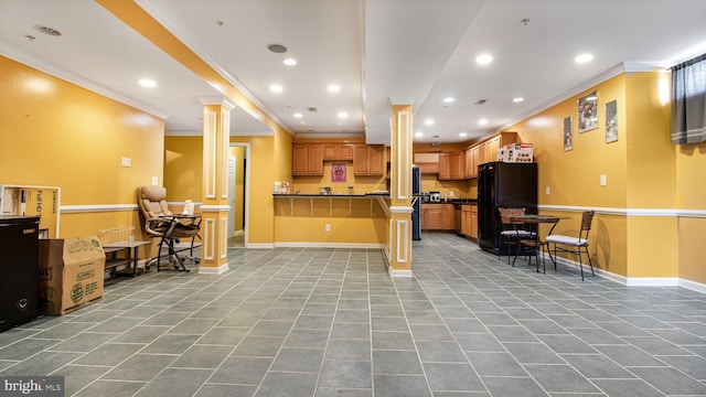 kitchen with tile patterned flooring, freestanding refrigerator, recessed lighting, and ornamental molding