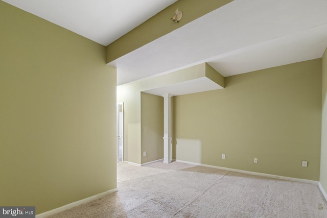 unfurnished room with carpet flooring and baseboards