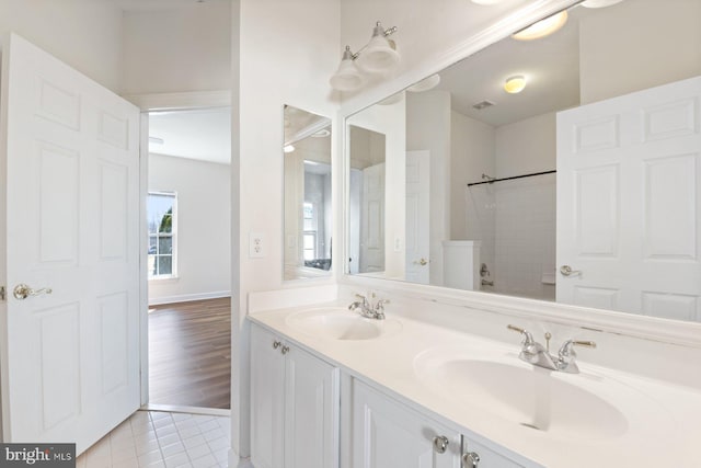 full bathroom with visible vents, tile patterned flooring, a sink, and double vanity