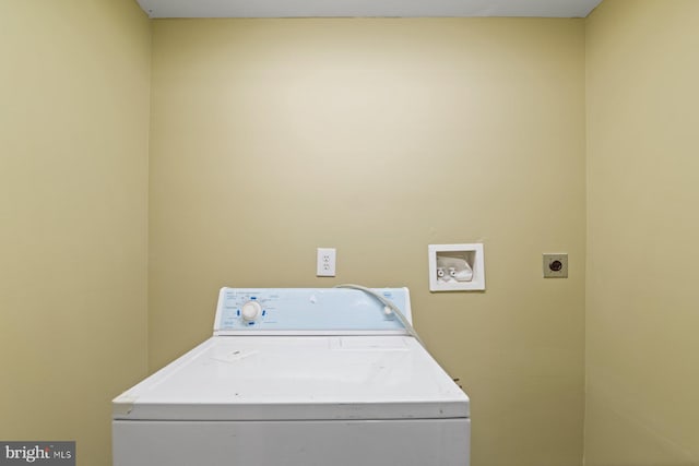 clothes washing area featuring washer / clothes dryer and laundry area
