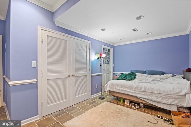 bedroom with a closet, baseboards, ornamental molding, and visible vents