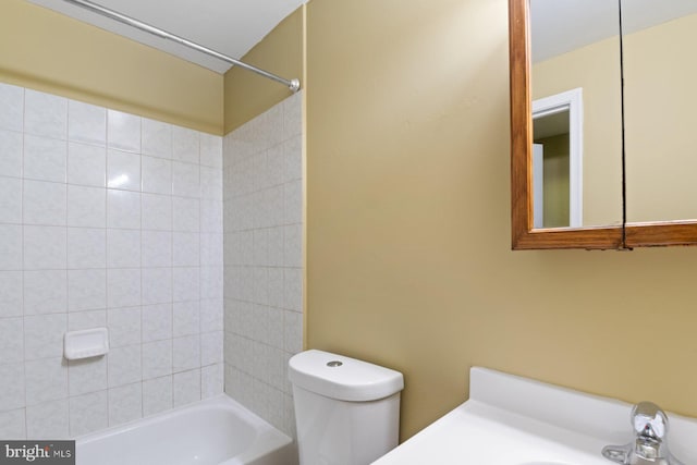 full bathroom featuring toilet, bathtub / shower combination, and a sink