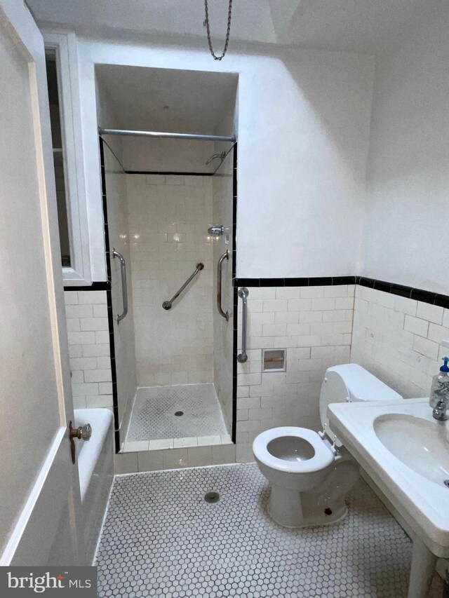 3418 Englewood St, Philadelphia, PA 19149 - bathroom with a shower stall, tile patterned flooring, tile walls, and a wainscoted wall