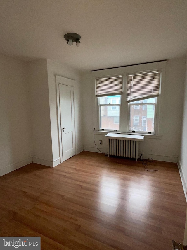 3418 Englewood St, Philadelphia, PA 19149 - spare room with baseboards, wood finished floors, and radiator