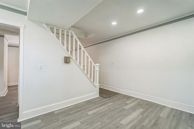basement with stairway, baseboards, recessed lighting, and wood finished floors