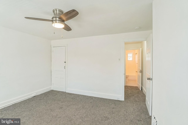 spare room featuring baseboards, carpet flooring, and a ceiling fan