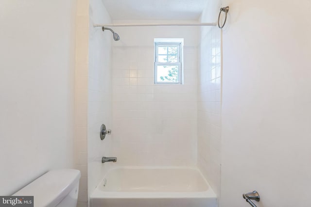 bathroom with bathtub / shower combination and toilet