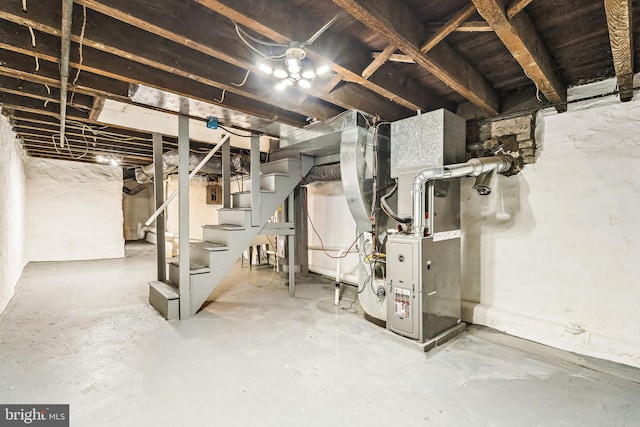 unfinished below grade area with stairs, heating unit, and electric panel