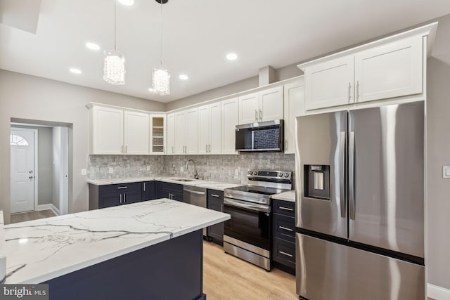 2954 Cedar St, Philadelphia, PA 19134 - kitchen with decorative backsplash, a sink, white cabinetry, and appliances with stainless steel finishes