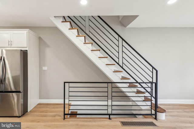 2954 Cedar St, Philadelphia, PA 19134 - staircase with baseboards, wood finished floors, and recessed lighting