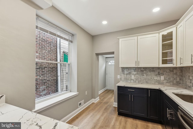 2954 Cedar St, Philadelphia, PA 19134 - kitchen featuring tasteful backsplash, dishwasher, dark cabinetry, white cabinets, and light stone countertops