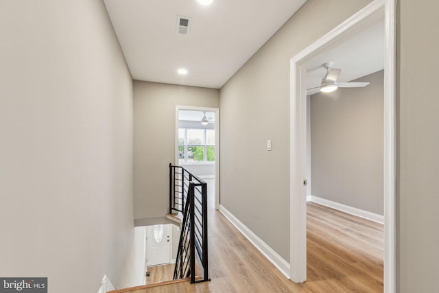 2954 Cedar St, Philadelphia, PA 19134 - corridor with baseboards, visible vents, an upstairs landing, and light wood finished floors