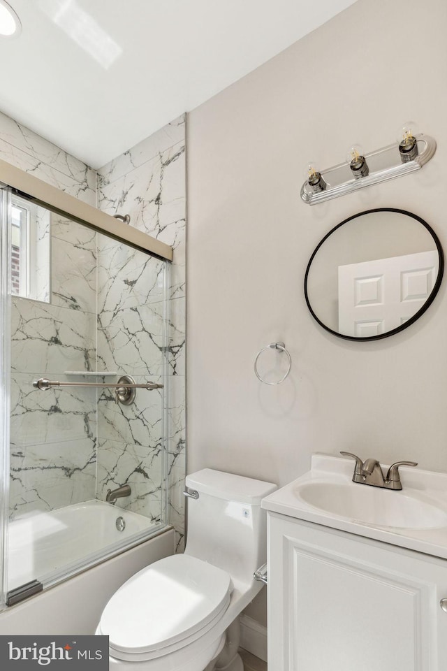 2954 Cedar St, Philadelphia, PA 19134 - bathroom featuring vanity, shower / bath combination with glass door, and toilet