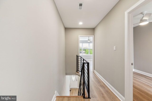 2954 Cedar St, Philadelphia, PA 19134 - hall featuring visible vents, baseboards, wood finished floors, and an upstairs landing