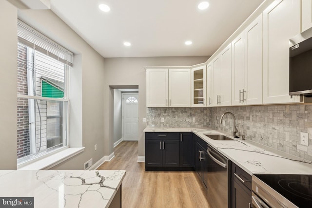 2954 Cedar St, Philadelphia, PA 19134 - kitchen with stainless steel appliances, light wood-style flooring, a sink, visible vents, and white cabinetry