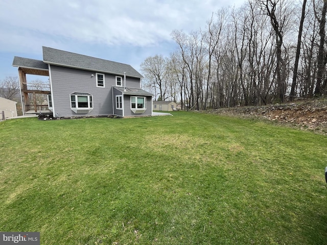 back of property featuring a yard and a balcony