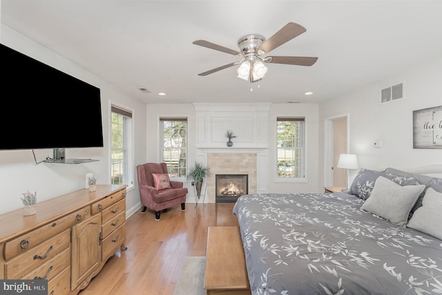 bedroom featuring multiple windows, light wood-style flooring, and visible vents