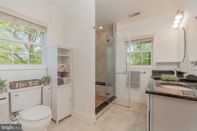 bathroom featuring double vanity, visible vents, a sink, and a stall shower