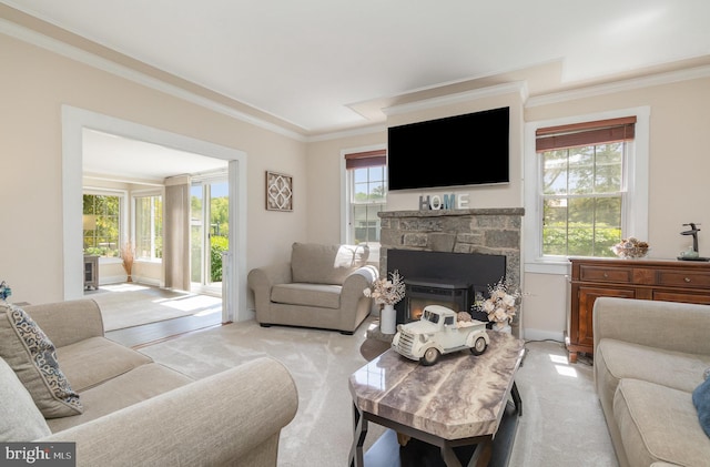 living room featuring ornamental molding, light carpet, and a stone fireplace