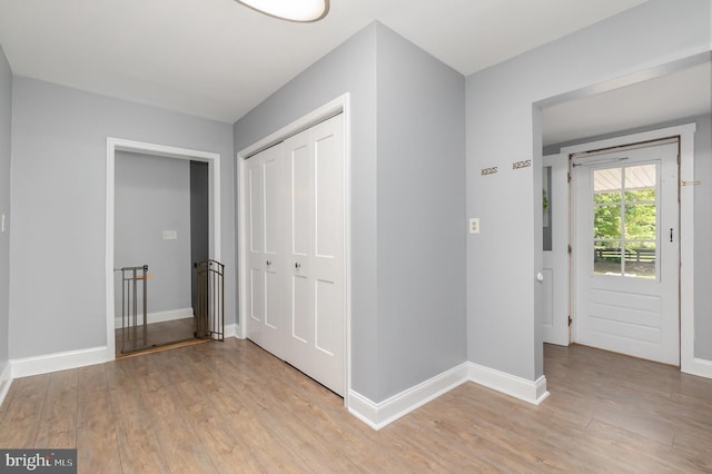 interior space featuring baseboards and light wood-style flooring